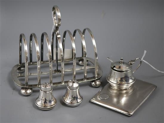 A silver cigarette case, a three-piece silver condiment set and a plated toast rack from the sailing vessel Arranmore